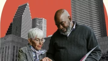 The image shows an older woman and an older man standing together in front of a backdrop of tall, modern skyscrapers. The woman, who has white hair and glasses, is pointing at a document the man is holding. The man, who is bald with a gray beard, is looking at the document while holding it open. Behind them, there is a large orange circle, creating a graphic contrast with the buildings, and a small blue-green circle above the orange shape, adding a decorative element to the composition. 